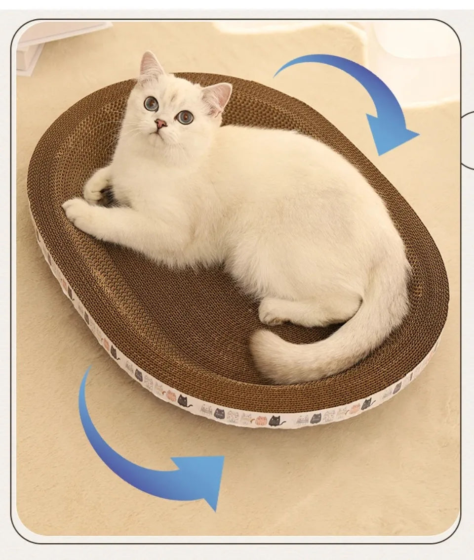 White cat on KittyNook Cat Co. Oval Corrugated Cat Scratching Board with rotating, furniture-protecting design.