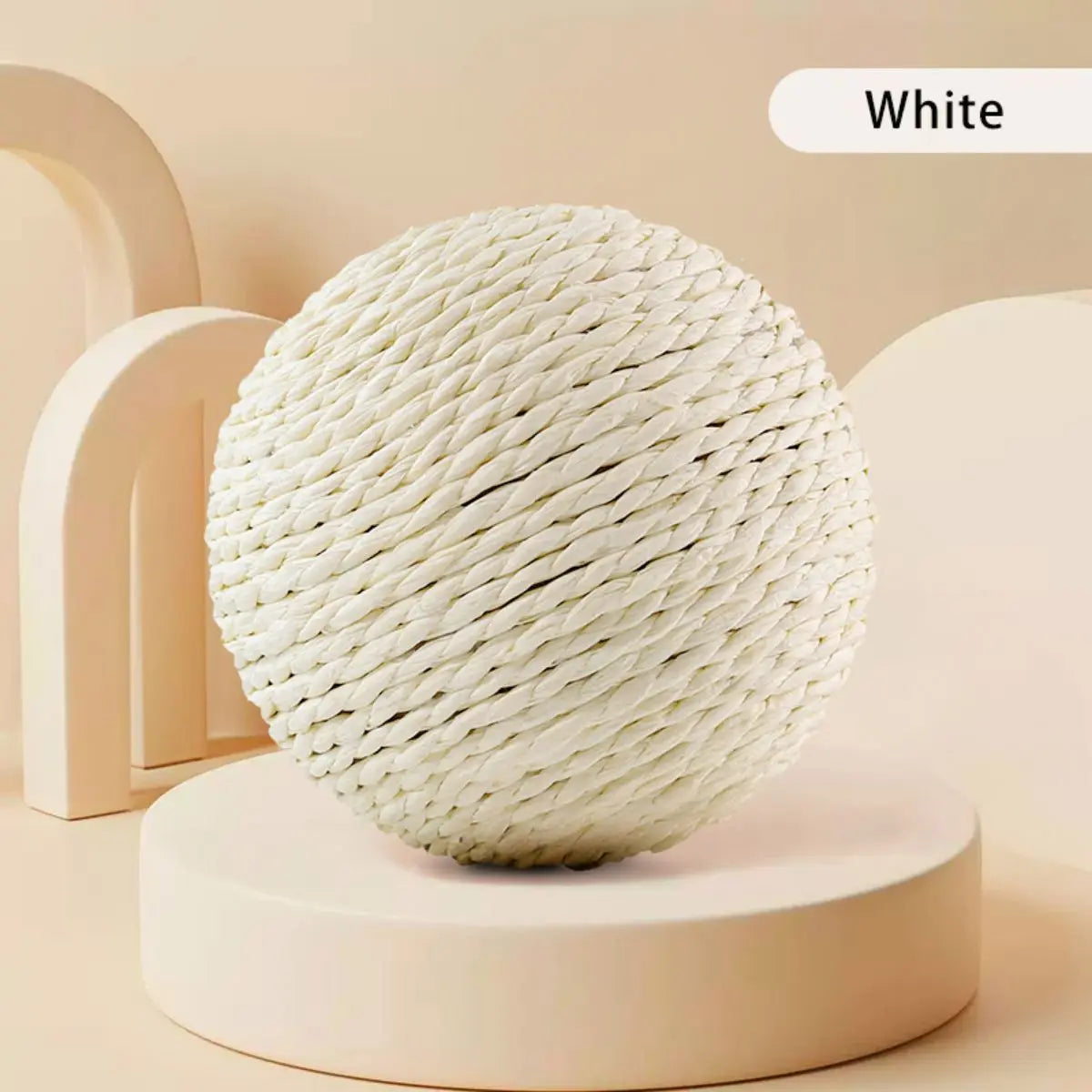 The KittyNook Cat Co. Premium Sisal Kitten Scratching Ball sits on a round pedestal against a beige background.