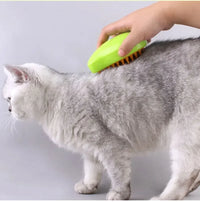 Thumbnail for A person uses the KittyNook Cat Co. SteamSoft Gentle Cat Brush on a gray and white cat against a light background.
