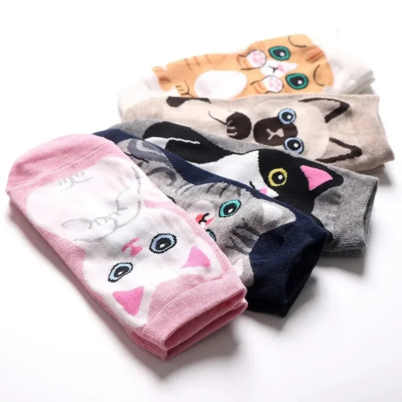 The Charming Kitties ankle socks by KittyNook Cat Co. feature cartoon cat faces in different colors and poses.