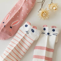 Thumbnail for Three pairs of KittyNook Cat Co. Sweet Kitty Pink Short Tube Socks with two delicate dried flowers nearby.