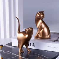 Thumbnail for KittyNook Cat Co.'s Golden Couples Cat Figurine, ideal as couples decor or a gift, displayed on a table and book.