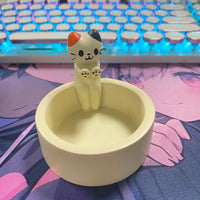 Thumbnail for The KittyNook Cat Co. Cute Kitten Candle Holder brings cozy charm to your desk beside your glowing keyboard.
