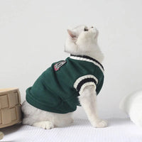 Thumbnail for White cat in a Cozy Fluff Cat Sweater by KittyNook Cat Co. sits upright on white, gazing up at a plain background.