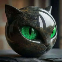 Thumbnail for The Eternal Cat Spirit Keepsake by KittyNook Cat Co. is round, shiny, and features vivid green eyes with a marble-like finish.