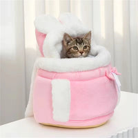 Thumbnail for A tabby cat lounges in The Stylish Pet Travel Bag by KittyNook Cat Co., featuring pink plush and white faux fur trim.