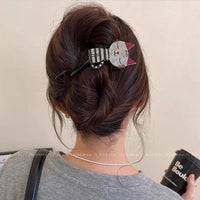 Thumbnail for Woman with brown hair in a bun, styled with The Acrylic Cat Hairpin by KittyNook Cat Co., holding a black tumbler.