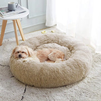 Thumbnail for A small dog lies comfortably in the KittyNook Cat Co. Warm & Soft Cat Sleeping Pod on a light carpeted floor.