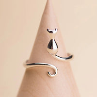 Thumbnail for The Cute Adjustable Silver Cat Ring by KittyNook Cat Co. is perfect minimalist jewelry with a curled tail design.
