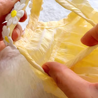 Thumbnail for Hands holding the KittyNook Cat Co. Adorable Cat Summer Dress Cute with ruffles and daisy strap details.