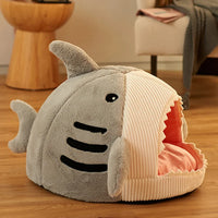 Thumbnail for KittyNook Cat Co. Shark-Shaped Cat Cave Bed with open mouth entrance on a wooden floor in a cozy room.