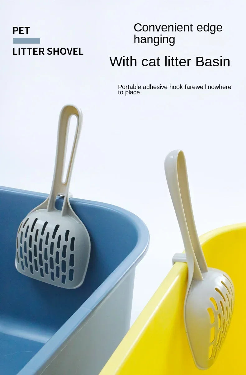 Two Curved Cat Litter Shovels by KittyNook Cat Co. hang on blue and yellow bins for easy, odor-free litter cleaning.