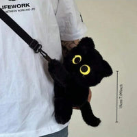 Thumbnail for A person holds The Cute Big Eyes Plush Backpack by KittyNook Cat Co., a black cat purse that's 18 cm tall.