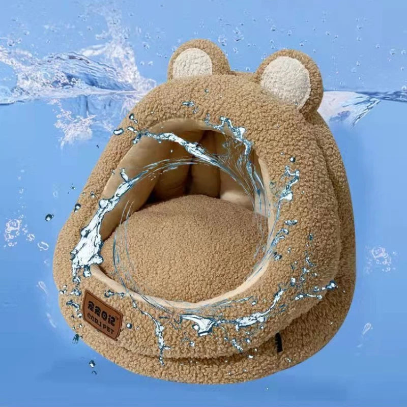 A cozy bear-shaped Ultra Soft Cat Nest by KittyNook Cat Co. with water splashes, set on a calming blue background.