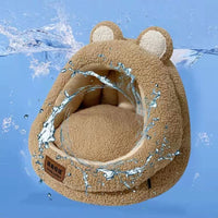 Thumbnail for A cozy bear-shaped Ultra Soft Cat Nest by KittyNook Cat Co. with water splashes, set on a calming blue background.
