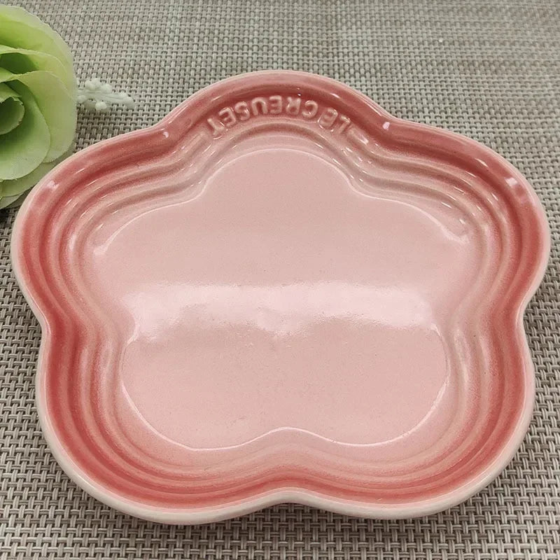 KittyNook Cat Co. Extra Wide Raised Flower Cat Bowl on a woven mat near a green artificial rose.