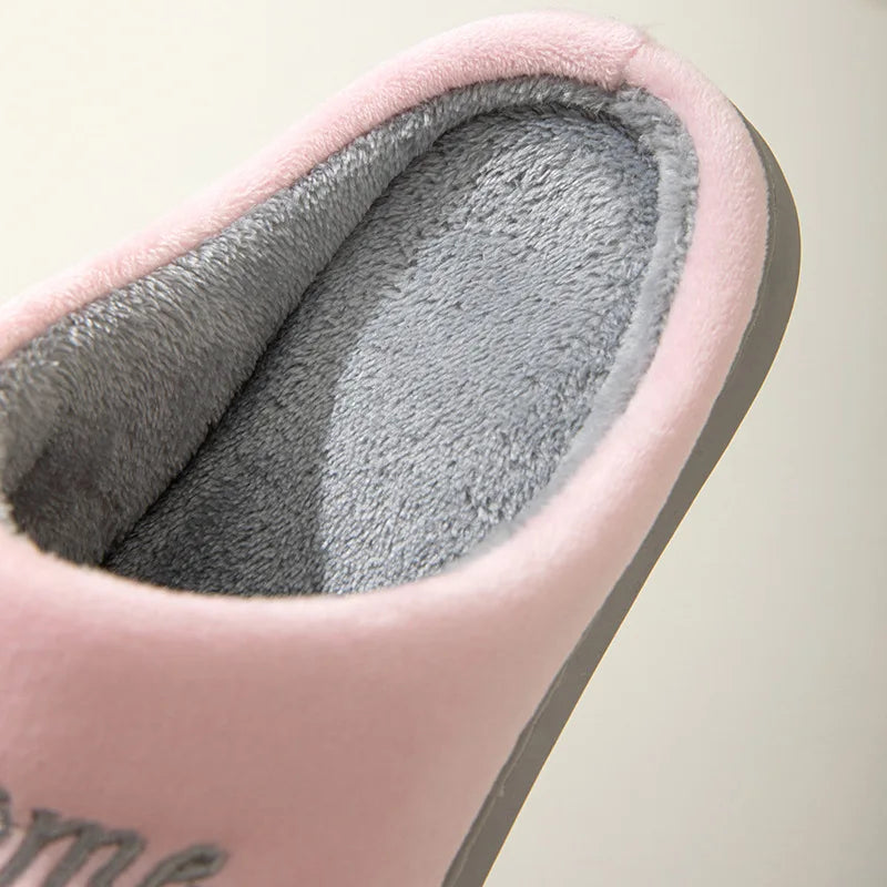 Close-up of KittyNook Cat Co. Happy Pawprints Lucky Cat Slippers, showing soft pink and gray plush lining and sole.