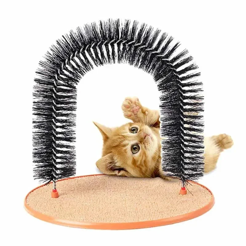 Orange kitten plays under the KittyNook Cat Co. 3-in-1 Cat Self-Grooming Arch Toy with round scratch pad.