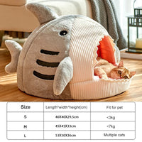 Thumbnail for An orange cat lounges in KittyNook Cat Co.'s Shark-Shaped Cat Cave Bed; size chart shows small, medium, and large.