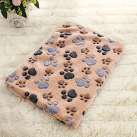 Thumbnail for The SnugglePaws Luxe Fleece Pet Blanket by KittyNook Cat Co. features blue and brown paw prints on soft fleece.