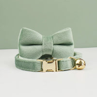 Thumbnail for KittyNook Cat Co. Velvet Cat Collar in sage green with bow, gold buckle & bell for a soft, purrfect fit.
