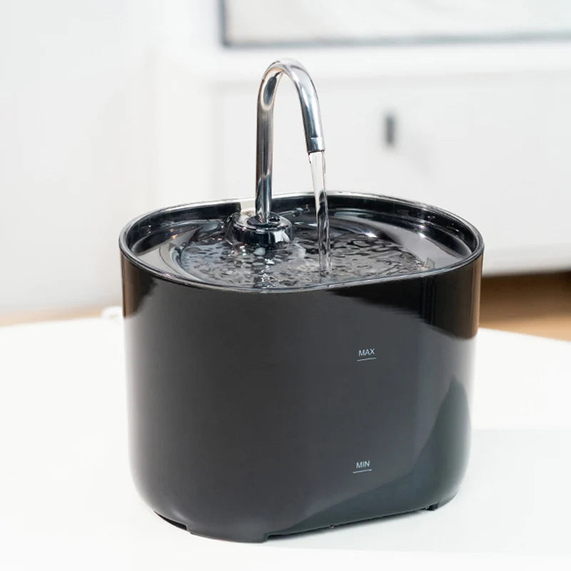 The KittyNook Cat Co. Cat Water Fountain Automatic Filter, black with metal spout, sits on a white surface.