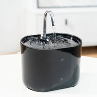 Thumbnail for The KittyNook Cat Co. Cat Water Fountain Automatic Filter, black with metal spout, sits on a white surface.