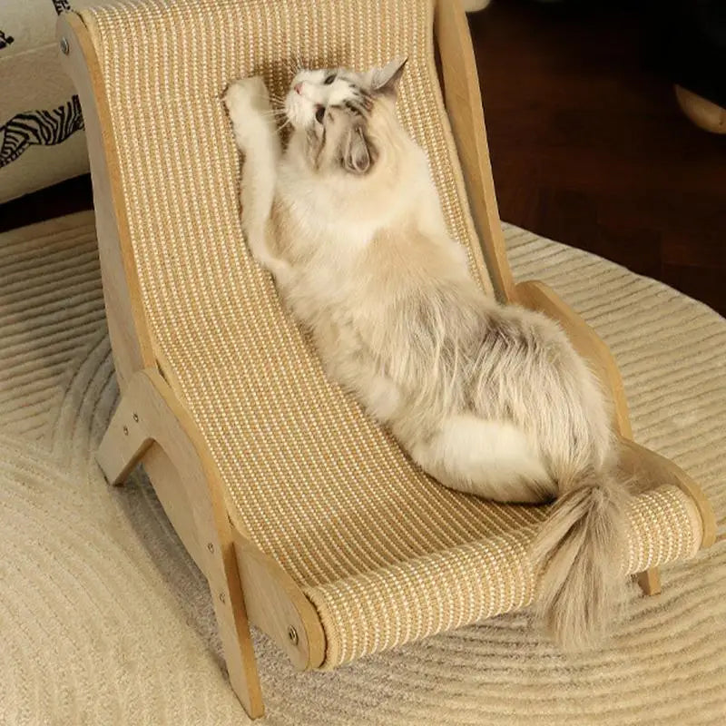 A fluffy cat lounges and scratches on the KittyNook Cat Co. Cat Sisal Wooden Chair in a warm, inviting room.