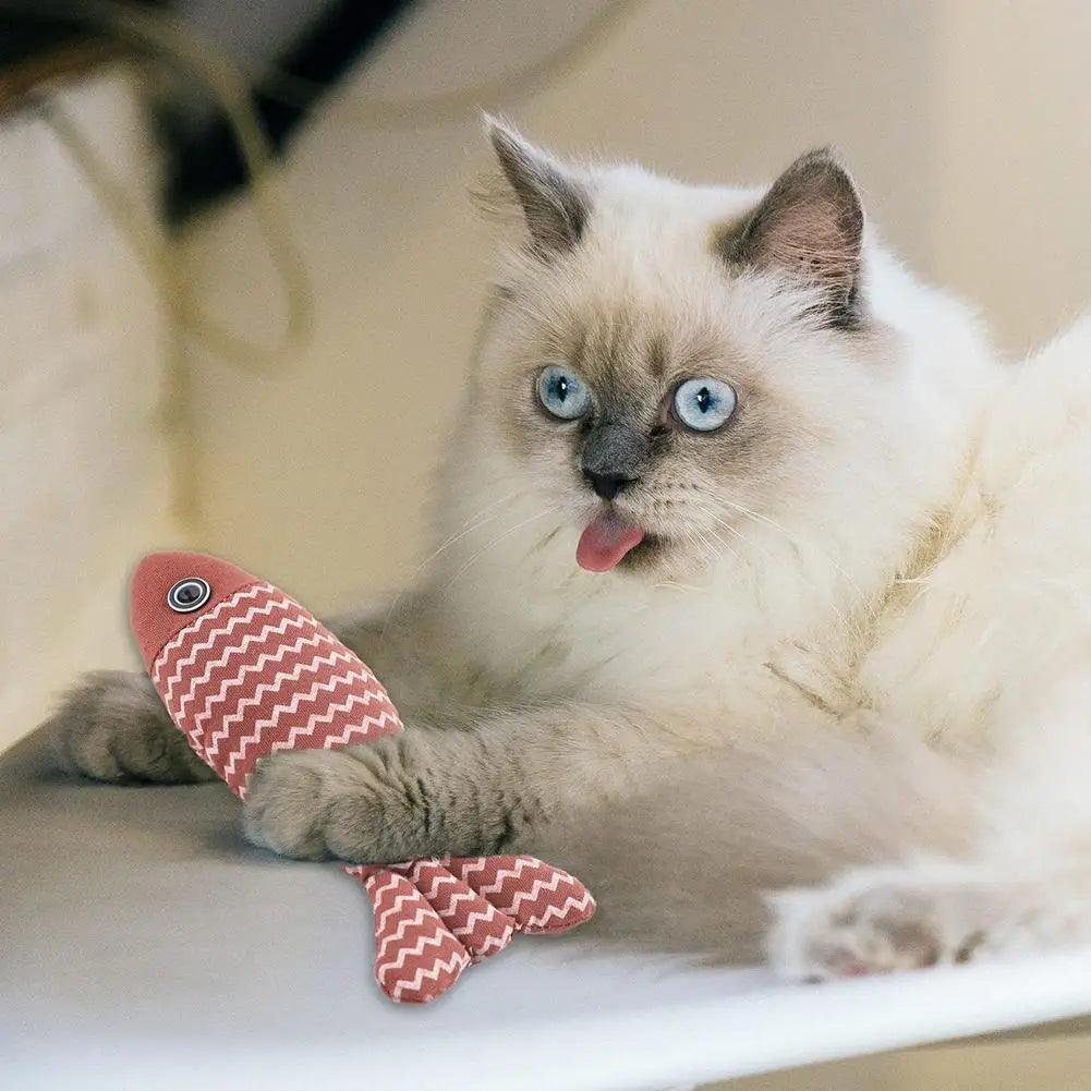 a siamese cat playing with Linen Catch Fish Toy in red
