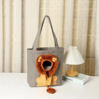 Thumbnail for KittyNook Cat Co. Lion Design Soft Cat Carrier Bag by a lamp and books on a white table with beige curtains behind.
