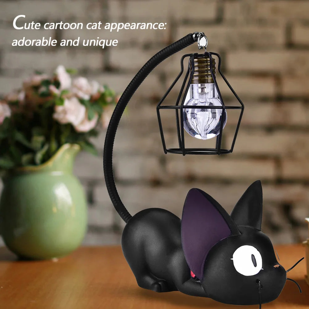 The KittyNook Cat Co. Cute Black Cat Night Light with a hanging bulb rests on a wooden table.
