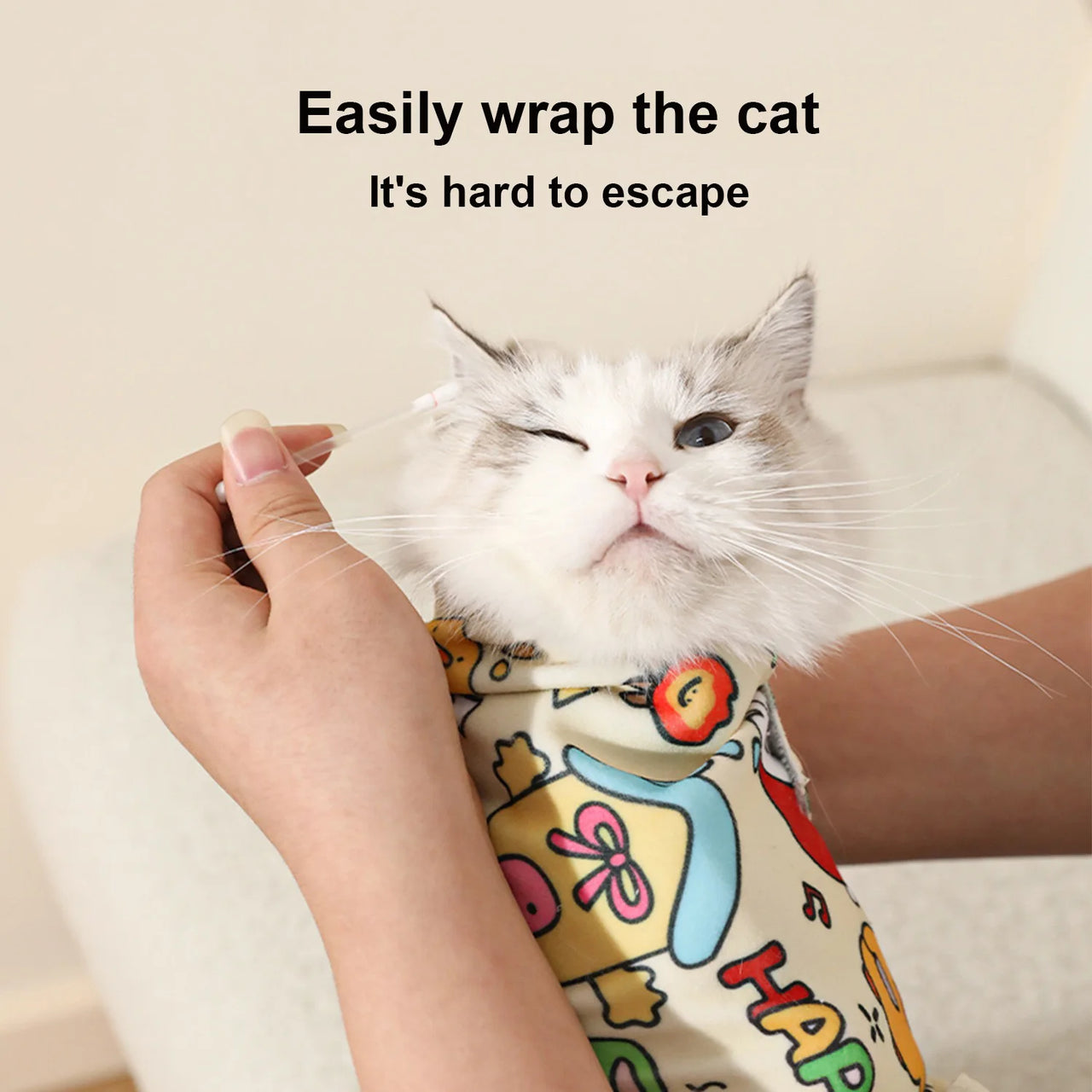 The KittyNook Cat Co. Cat Burrito Grooming Wrap snuggly swaddles cats for gentle, safe ear cleaning.