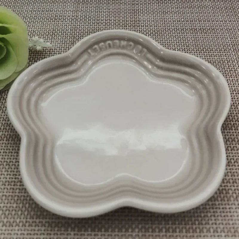 KittyNook Cat Co. Extra Wide Raised Flower Cat Bowl on woven beige surface, green faux flower in top left corner.