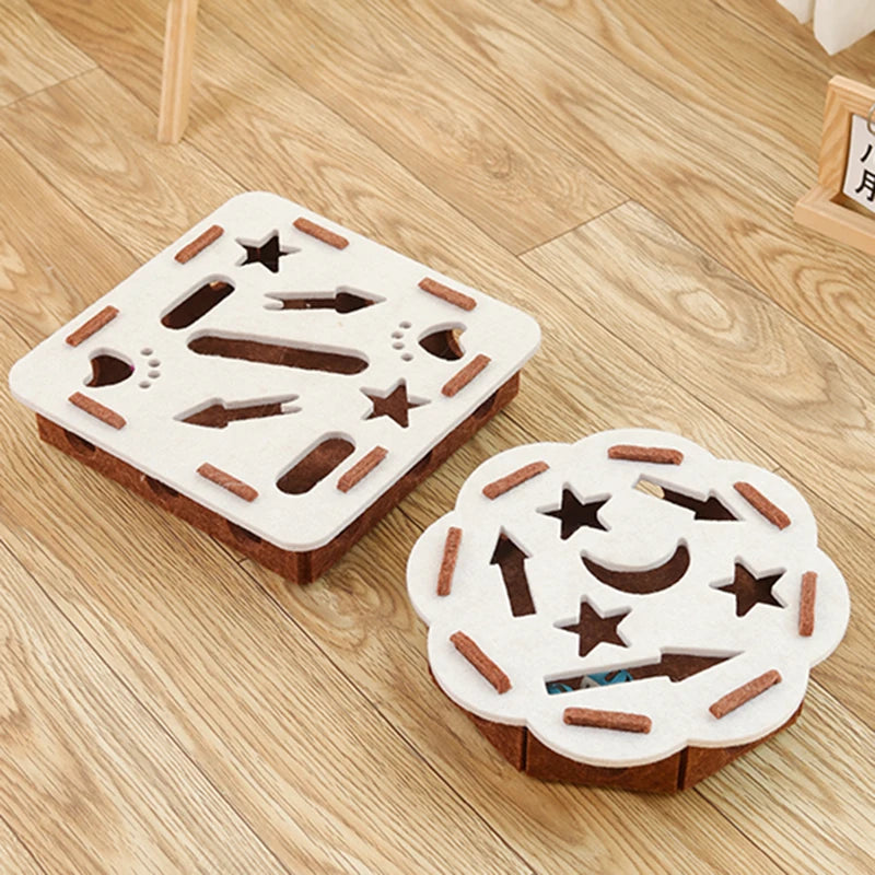 KittyNook Cat Co.’s Ultimate Puzzle Box Toy features star and moon patterns, providing pets enrichment on a wooden floor.