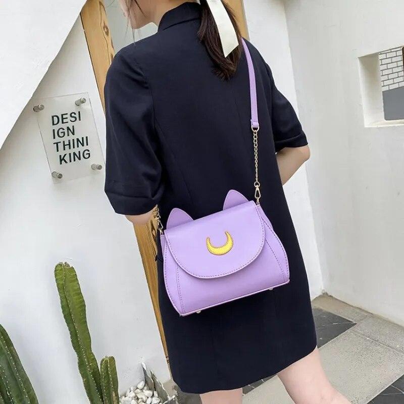A Woman Carrying the Luna Crescent Hand Bag in Purple
