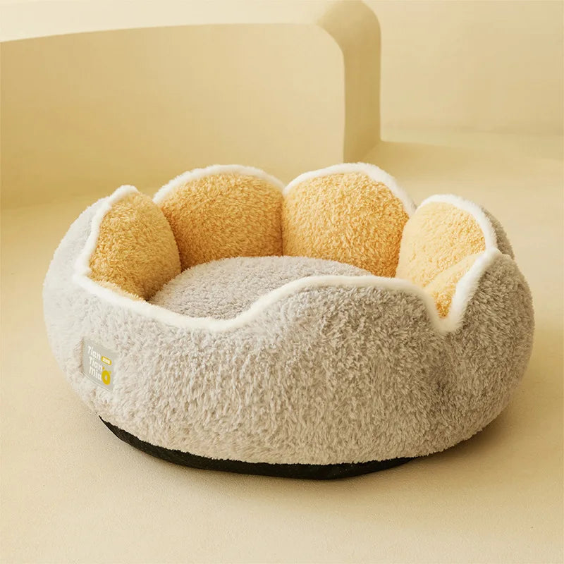 The KittyNook Cat Co. Warm & Soft Cat Sleeping Pod is a plush, flower-shaped bed in grey and yellow fabric.