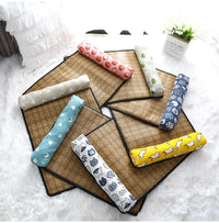 Thumbnail for Seven KittyNook Cat Co. Natural Rattan Cat Sleeping Mats on a white rug, with neck pillows beside a plant.