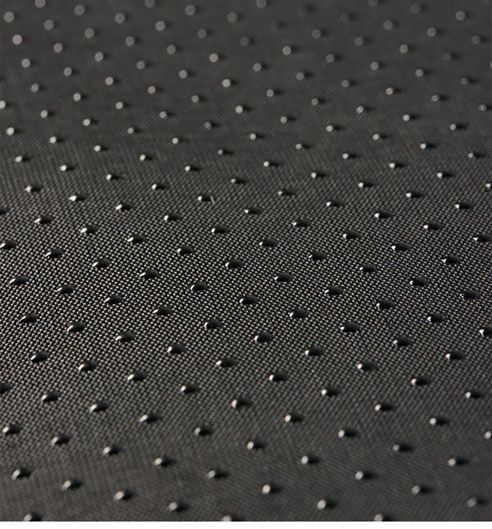 Close-up of the black textured surface of KittyNook Cat Co.'s Shark-Shaped Cat Cave Bed, with raised grid dots.