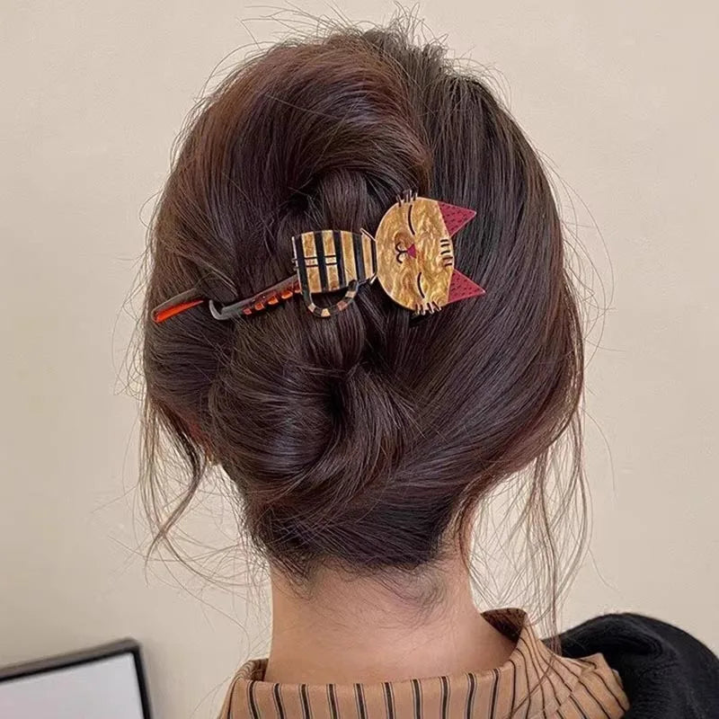 Woman with brown hair in a twist, secured by The Acrylic Cat Hairpin from KittyNook Cat Co.—great cat lover gift.