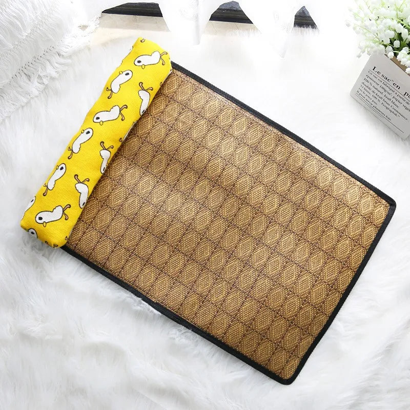 KittyNook Cat Co. Natural Rattan Cat Sleeping Mat with yellow pillow and white cartoon rabbits on white fur.