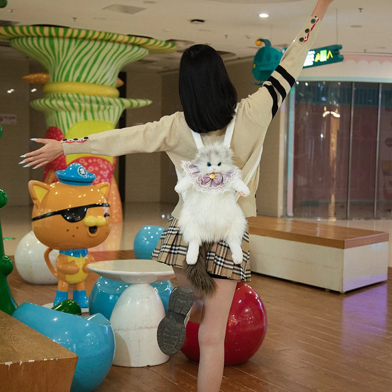 A person with outstretched arms wears The Purrfect Cat Lover’s Bag by KittyNook Cat Co. in a colorful play area.