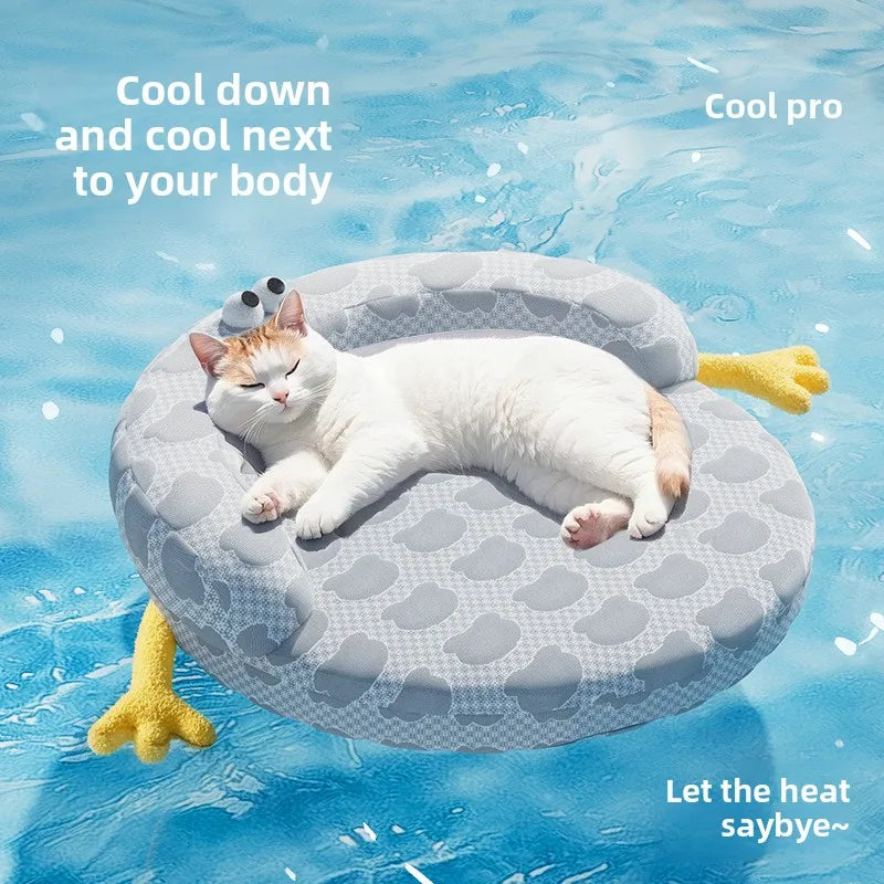 A relaxed cat lounges on the Ice Silk Cat Nest by KittyNook Cat Co., perfect for cooling off in the pool this summer.