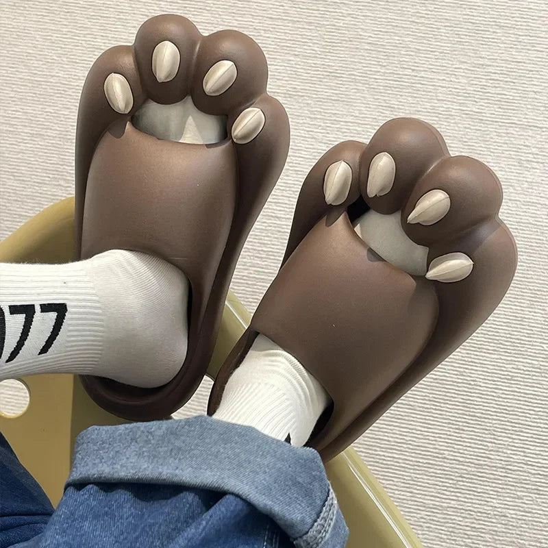 KittyNook Cat Co.'s Comfy Outdoor Cat Slippers, worn with white socks and jeans, offer cozy comfort on a chair.