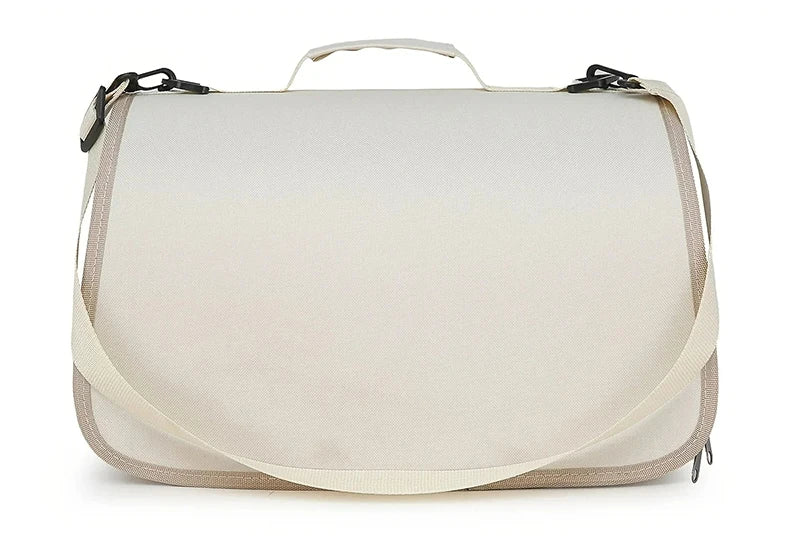 The KittyNook Cat Co. Portable Pet Carrier Bag is a beige messenger bag with a flap, top handle, and adjustable strap.