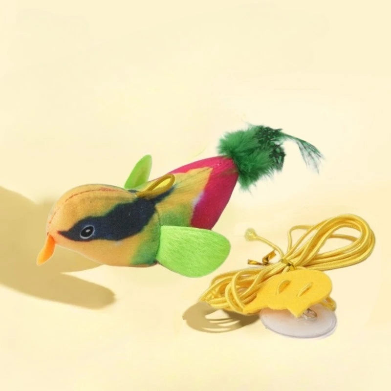 The Ultimate Interactive Chirping Bird Cat Toy by KittyNook Cat Co. hangs by yellow string and suction cup.
